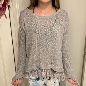 Grey sweater with laced bottom.